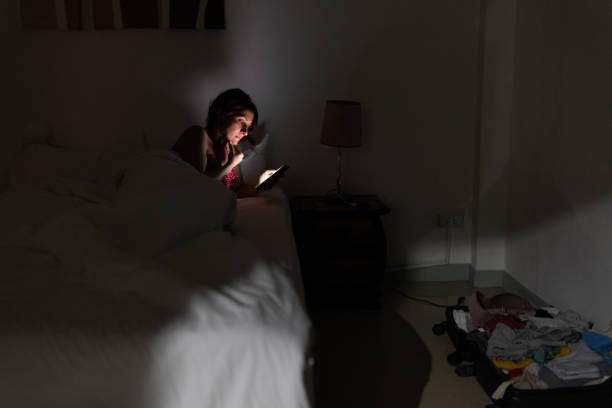 istock Woman using phone in bed late at night 2017581947