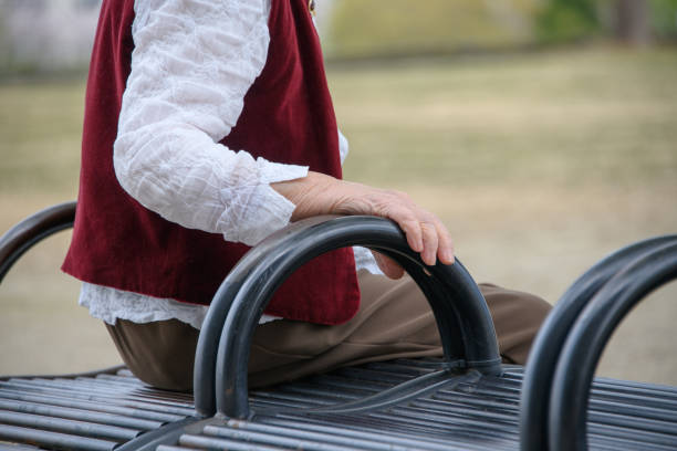 istock senior woman sitting on a bench 2017583518