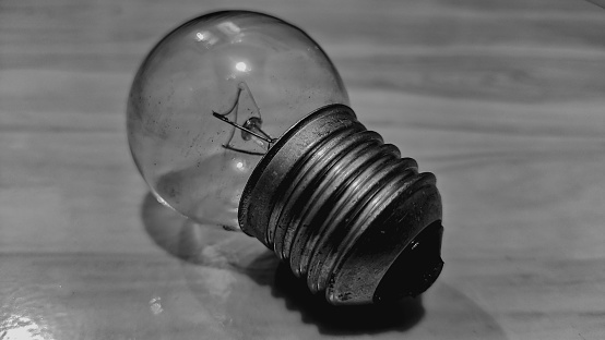 close-up of a glass light bulb, the light bulb is lying on the floor