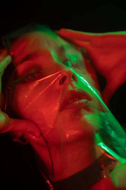 Close up portrait of woman under plastic reflective layer