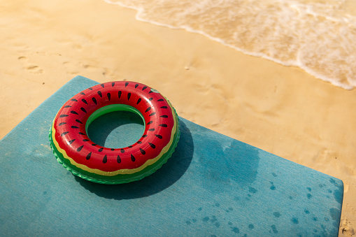 Swim ring for children on deck chair on the beach by the sea outdoors.