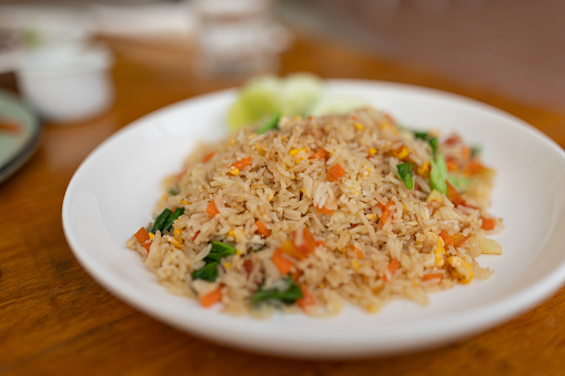 Fried rice on a white plate in restaurant, Thai cuisine.