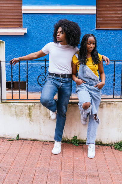 istock Relaxed Afro-Latino Friends Leaning on a Blue House Railing 2017612313