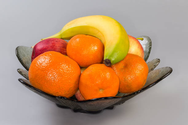 fresh fruits in a bowl on a plank