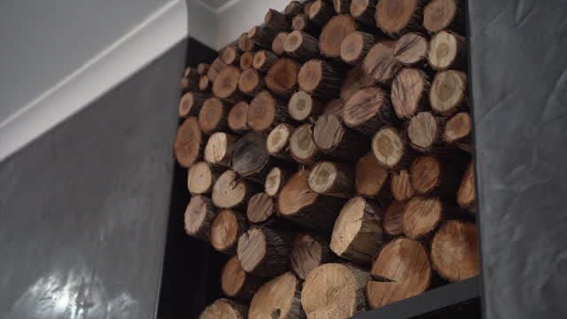 A large pile of dry firewood in a house, to keep a warm fire burning throughout the cold winter.