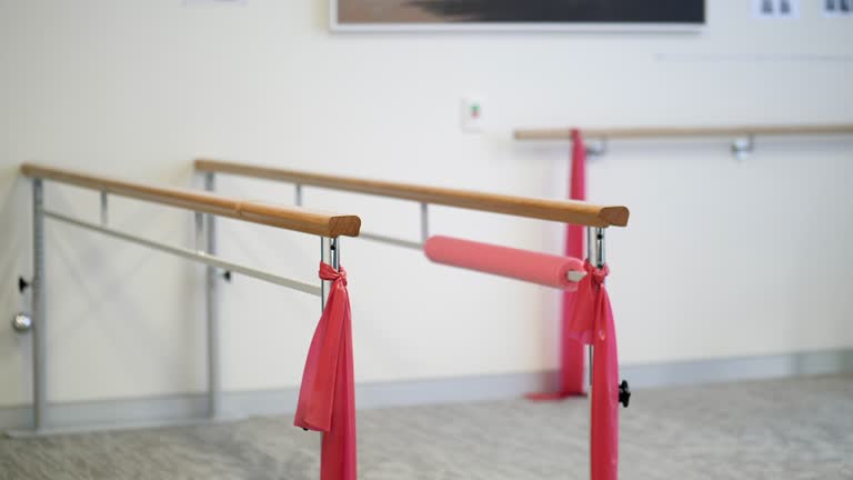 Parallel bars and elastic bands used for support during injury rehabilitation and recovery in a physical therapy gym