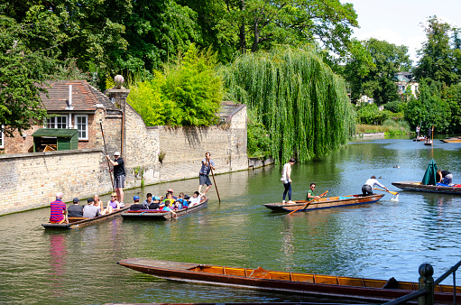 27th July, 2014 - Cambridge, England: On a bright summer's day, the historic city of Cambridge bustles with a mix of tourists and locals. The streets, river and famous college greens are alive with activity, as people enjoy the rich academic heritage, architectural beauty, and vibrant culture that Cambridge offers under the warm summer sun.