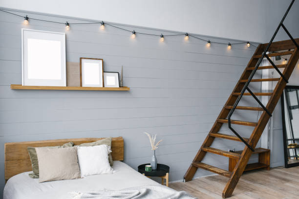 istock Stylish Scandinavian open space with a bed and stairs to the second floor. A designer room with gray walls. 2017682350