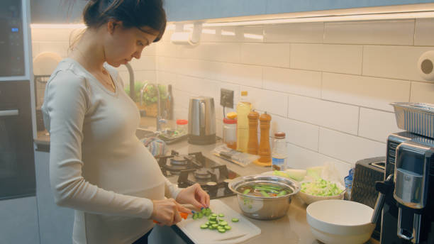 istock Pregnant woman chopping vegetables for salad 2017693930