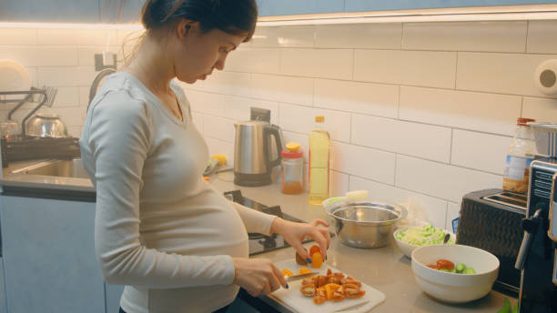 istock Pregnant woman preparing dinner at home 2017694485