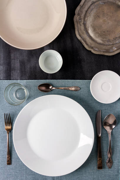 istock Plates, cutlery and tablecloth on black table top view. 2017696650
