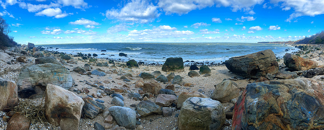 panoramic view of boulders and the water on a Long Island Sound beach,  on the North Fork, Long Island, New York State