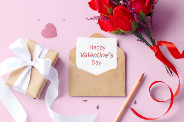 istock Valentine card in kraft envelope with gift box and rose on pink background 2017750086