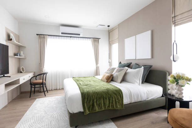 istock Stylish bedroom with modern green and brown pillow on bed. 2017753354