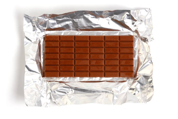 istock Bar milk chocolate lies on foil. 2017753907