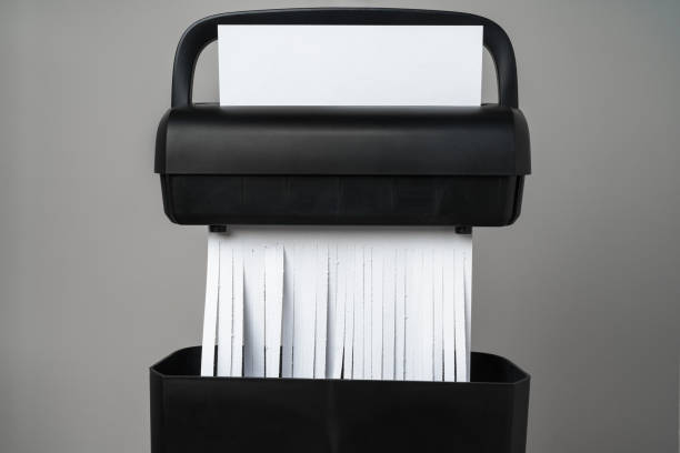 istock Black paper shredder cutting paper on gray background 2017763888