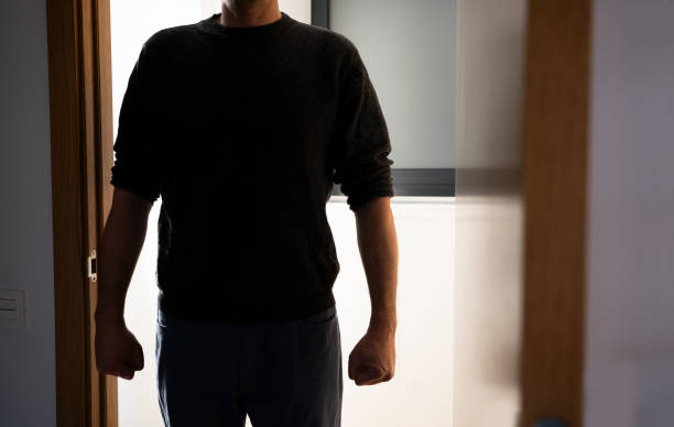 istock man appears in silhouette on the door 2017773417