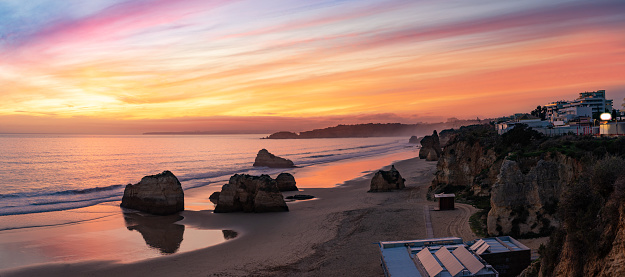 Portimao sunset in Praia dos Tres Castelos beach in Algarve of Portugal