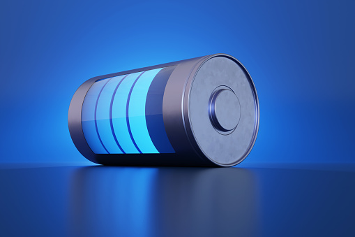 Silver battery laid flat on a reflective surface with a transparent glass window showing the glowing energy level on blue background. Illustration of the concept of electric vehicle (EV) cells