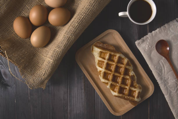 istock Waffles and coffee with boiled eggs on rustic wood background 2017868045
