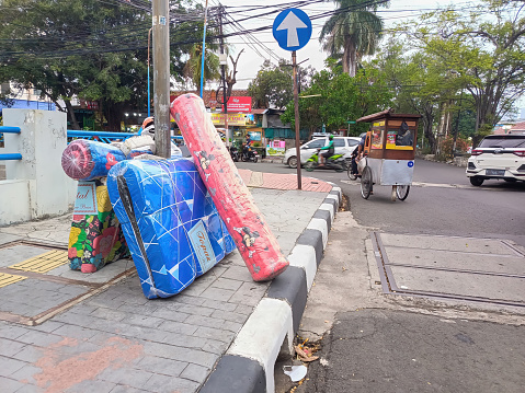 Jakarta, Indonesia - November 19, 2023: A mattress seller leaves his wares on the sidewalk