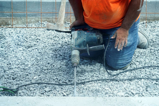 istock manual worker operating drill to repair the road 2017999451