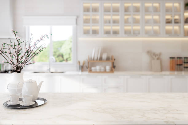 istock Close up view of modern vintage style empty white marble top table for copy space with blurry kitchen background 3d render 2018023957