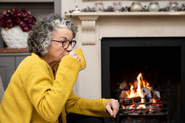 istock Mature woman sitting on a sofa and drinking a coffee 2018024984
