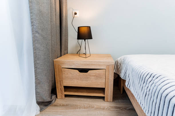 istock Cozy interior design with furniture, wood flooring, and comforting lighting in a rectangular bedroom of a property. 2018029711