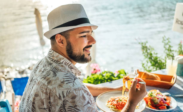 istock Man having lunch in a seaside restaurant 2018033958