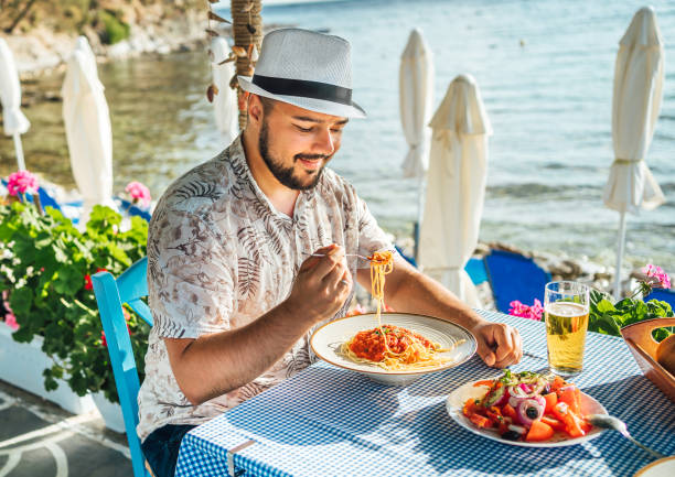 istock Man having lunch in a seaside restaurant 2018034499