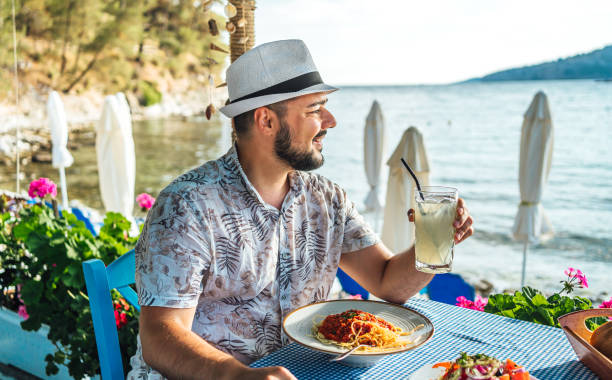 istock Man having lunch in a seaside restaurant 2018035025