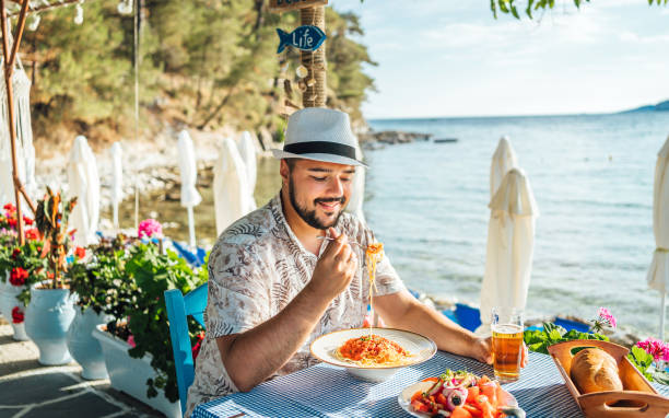 istock Man having lunch in a seaside restaurant 2018037114