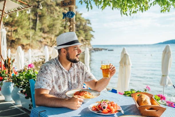 istock Man having lunch in a seaside restaurant 2018037137