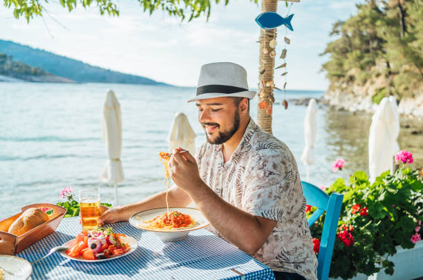 istock Man having lunch in a seaside restaurant 2018040843