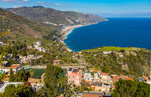 Taormina, Sicily, Italy - February 15, 2023: Panoramic Sicilian view of Ionian sea shore of Taormina and Mazzaro in Messina region of Sicily