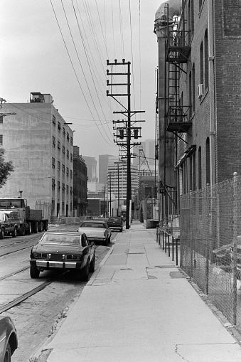 Archival 1985 black and white editorial view of Banning Street near Santa Fe Ave in downtown LA.  Shot on film.  Brick warehouses have been torn down.