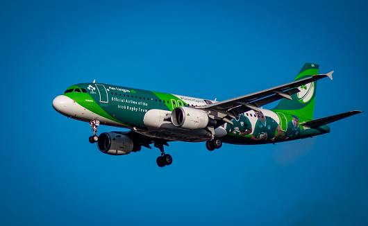 Official aircraft of the Irish Rugby Team on approach to London Heathrow in December 2019 amid a bright blue azure sky