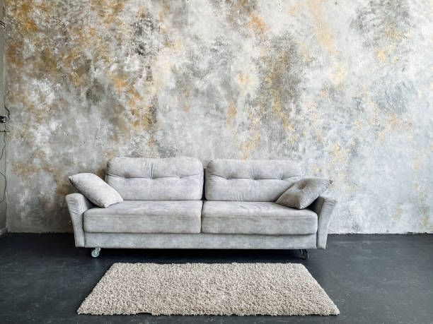 istock Rectangular modern living room with a grey couch, wooden furniture, and a studio couch as a sofa bed. Grey table and wooden flooring. 2018076419