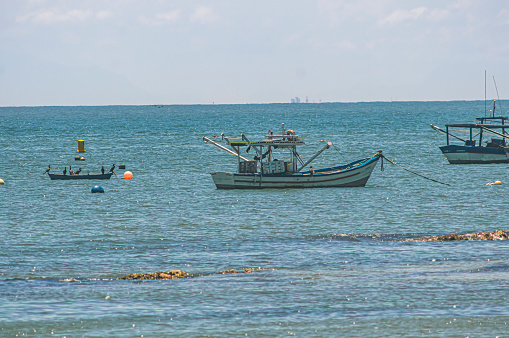 Penha-sc,brazil-February 10,2024 : Boats stopped at sea, fishermen's boats stopped on the beach on a sunny day, beach of trapiche-Penha-santa catarina.