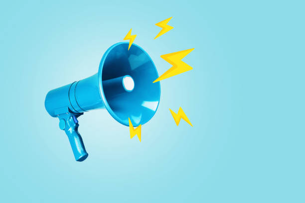 istock Creative blue loudspeaker with yellow lightning bolts on a blue background. Creative idea, attention! Urgent news. Lightning traffic, advertising and message. 2018084854