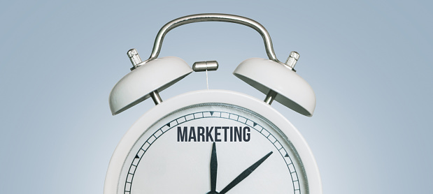 Marketing time, creative idea. Vintage white Clock and arrows point to marketing, concept. Successful business development. Time to marketing