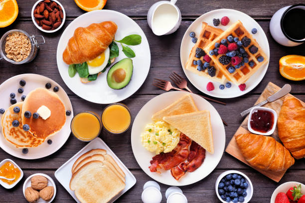 istock Breakfast or brunch table scene on a dark wood background. Overhead view. 2018089052