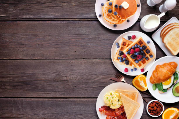 Breakfast or brunch side border on a dark wood background. Above view.