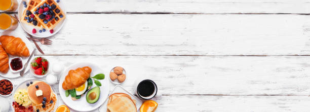 istock Breakfast or brunch corner border on a white wood banner background. Overhead view. 2018089569
