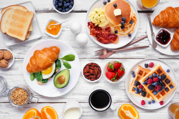 istock Breakfast or brunch table scene on a white wood background. Top view. 2018089581