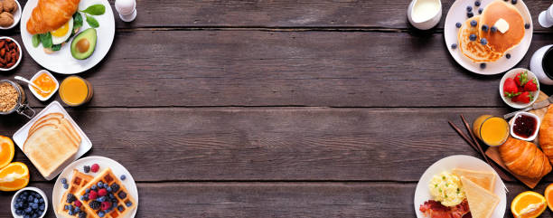 istock Breakfast or brunch double border on a dark wood banner background. Overhead view. 2018089582