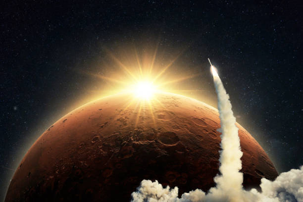 istock New space shuttle rocket with a blast and smoke takes off into space on background of the red planet Mars and sunrise light. Concept of technology and travel to Mars. Spaceship lift off 2018090597