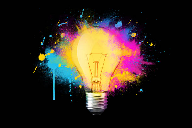 istock Creative light bulb explosion with splashes of yellow, blue and pink paint on a black background. Think differently, creative idea. Brainstorm 2018098840