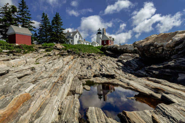 farol de pemaquid point e reflexo da torre do sino em poça em um dia brilhante de verão pontilhado de nuvens inchadas - maine lighthouse reflection pemaquid point lighthouse - fotografias e filmes do acervo